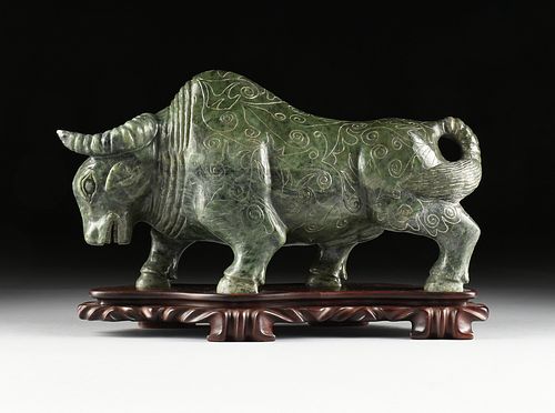 A LARGE CHINESE CARVED DARK GREEN