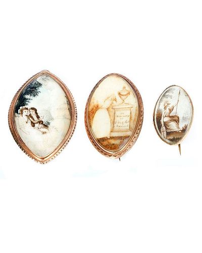 THREE ANTIQUE SEPIA MOURNING BROOCHES/PENDANTS.Navette-shaped