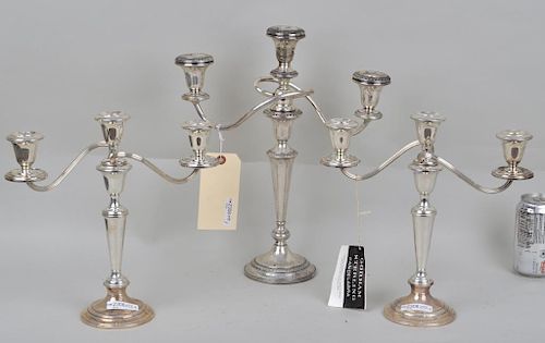 GROUP THREE STERLING WEIGHTED CANDELABRAcomprising