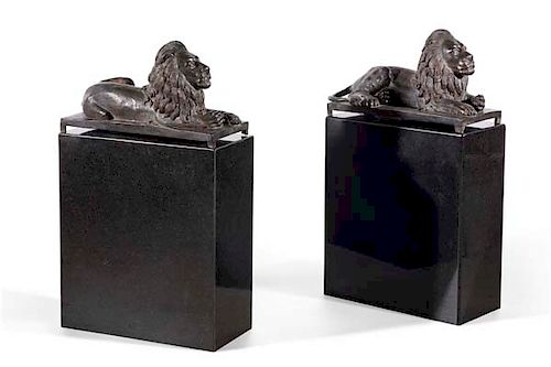 A PAIR OF BRONZE FIGURES OF RECUMBENT