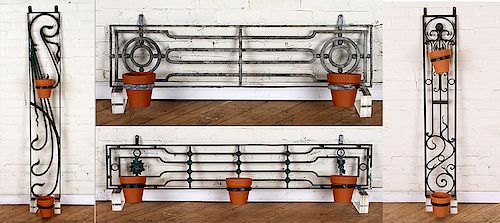 A SET OF FOUR WROUGHT IRON WALL MOUNT