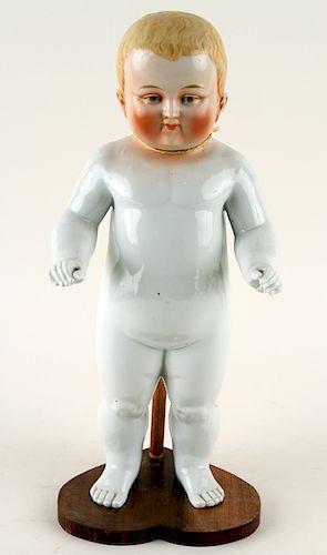PORCELAIN FIGURE OF A BABY ON WOOD STAND