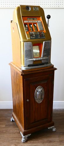 MILLS 50 CENT SLOT MACHINE ON WOODEN