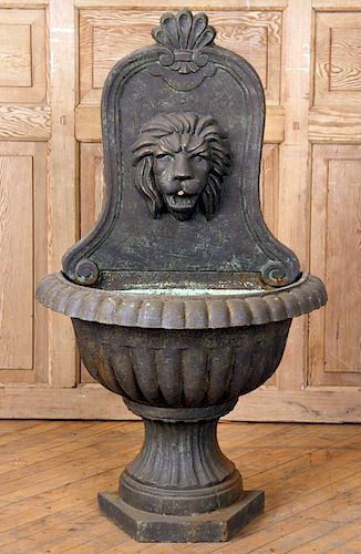A CAST IRON WALL FOUNTAIN WITH