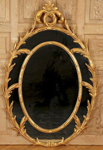 LARGE OVAL GILT MIRROR WITH FOLIATE