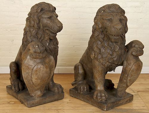 PAIR OF OPPOSING STONE SEATED LIONSA