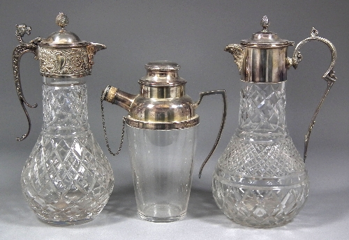 A cut-glass water jug with plated mounts