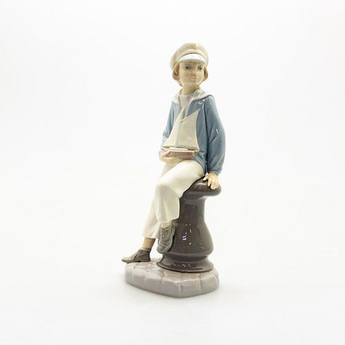 LLADRO FIGURINE, BOY WITH YACHTPorcelain;