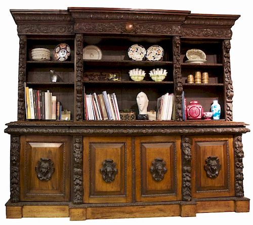 A CONTINENTAL CARVED OAK BOOKCASE,