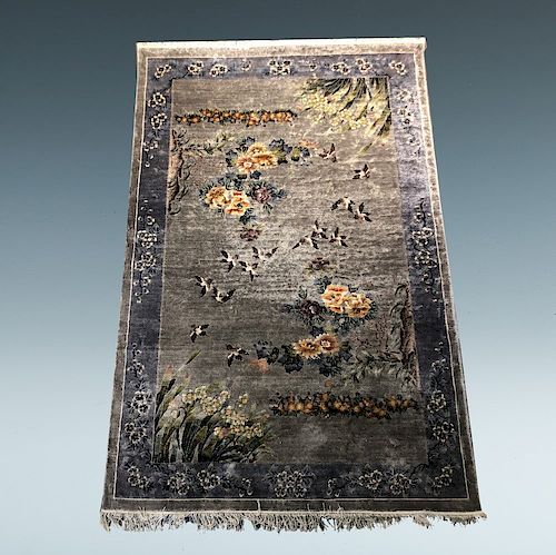 A WOOL RUGA rug depicting birds