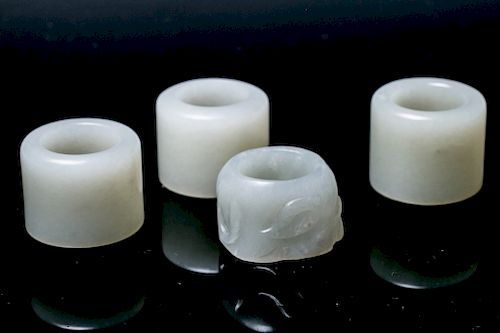 A SET OF FOUR JADE THUMB RINGSThe