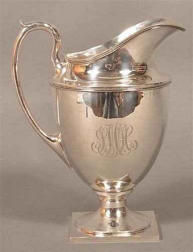 STERLING SILVER FOOTED WATER PITCHER.Sterling