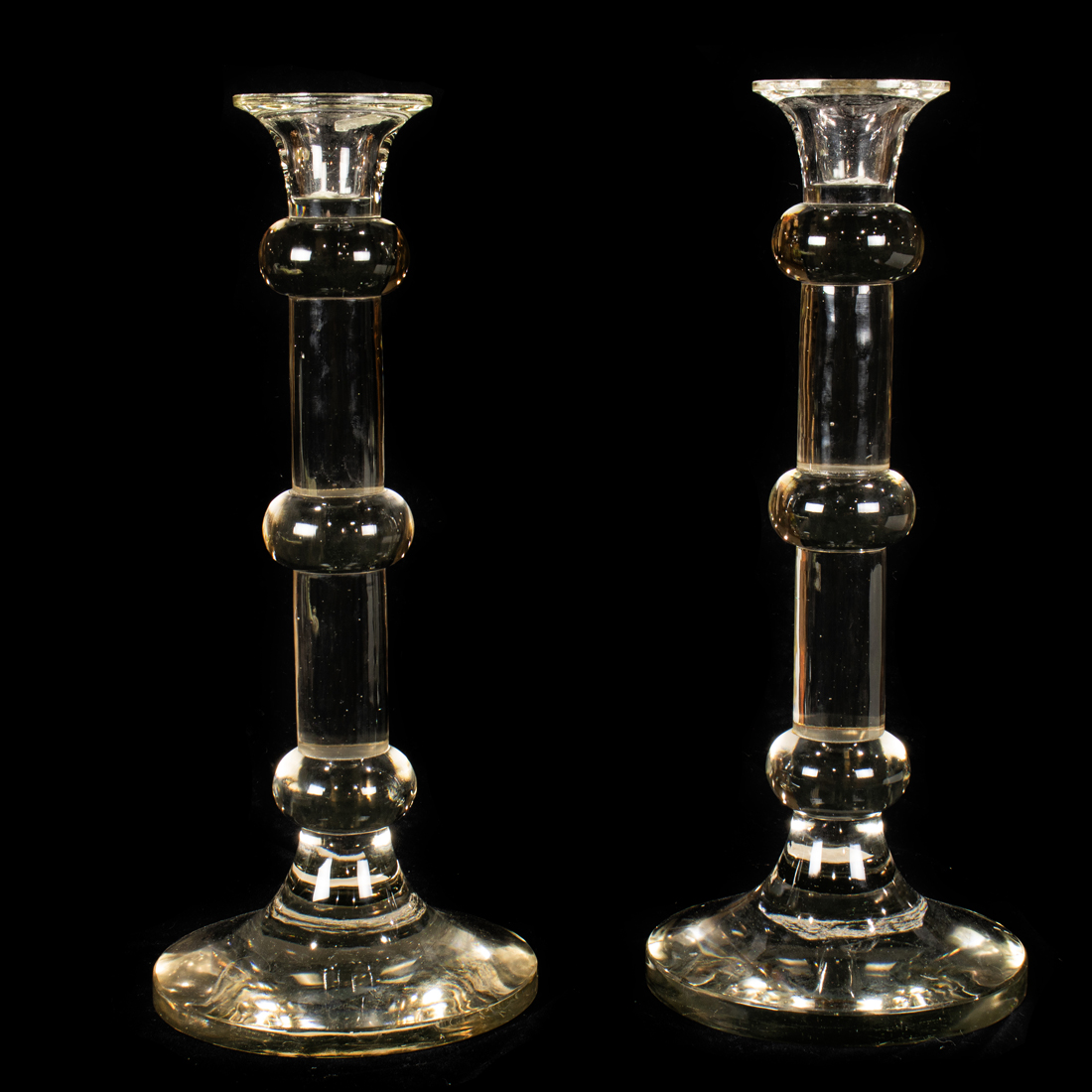 A TALL PAIR OF GLASS CANDLE HOLDERS