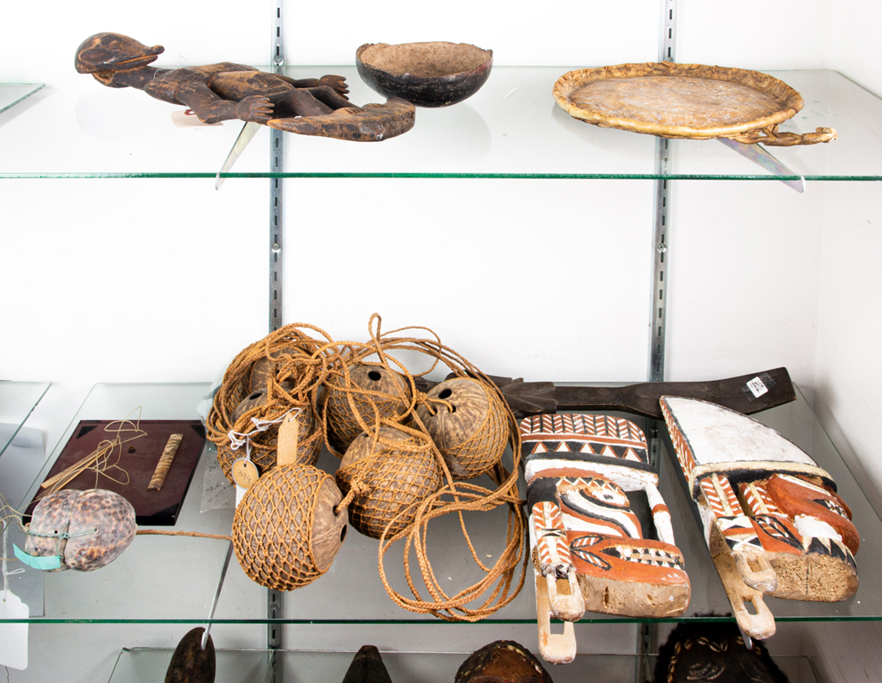 TWO SHELVES OF OCEAN AND TRIBAL ART