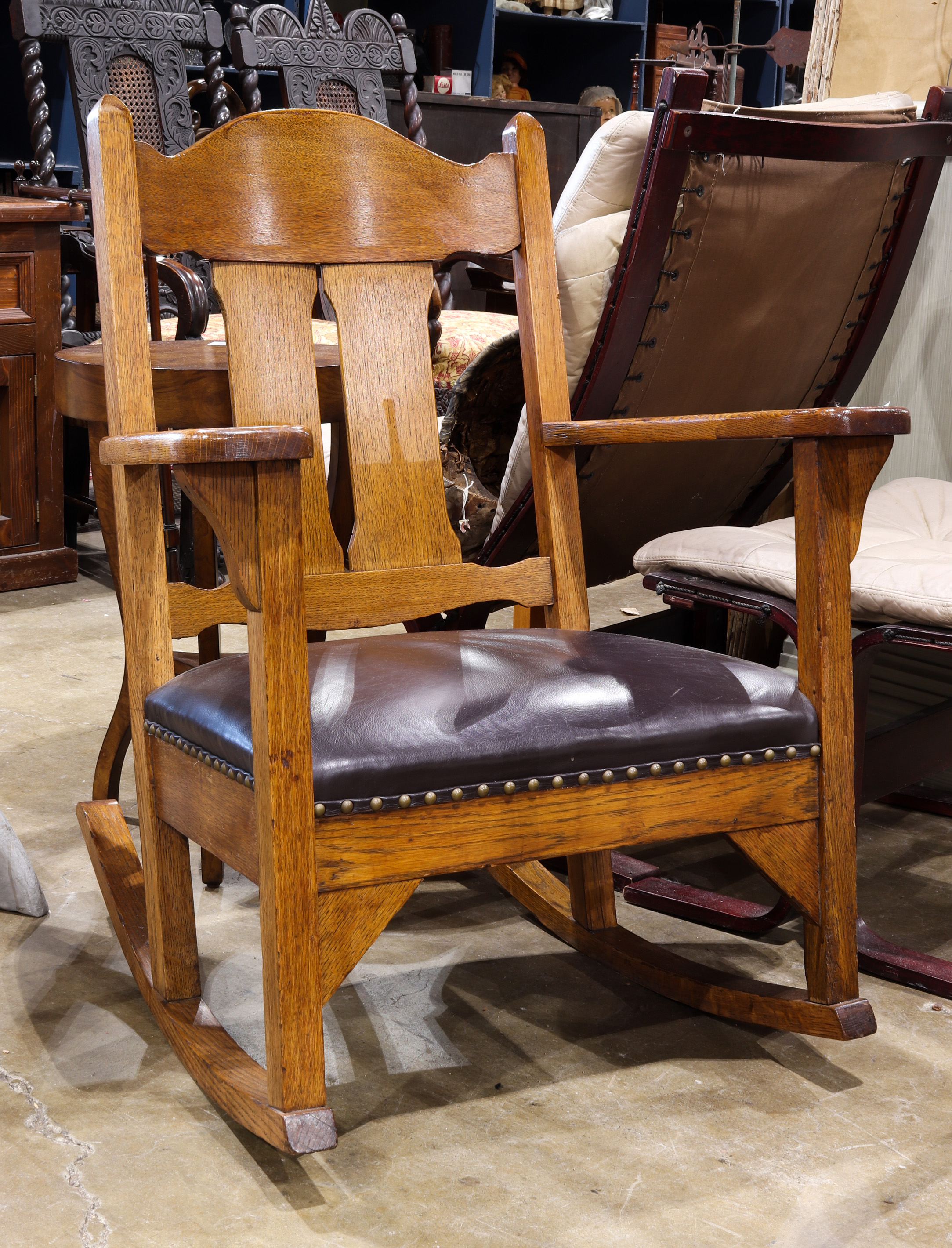 AN ARTS AND CRAFTS OAK ROCKING CHAIR,