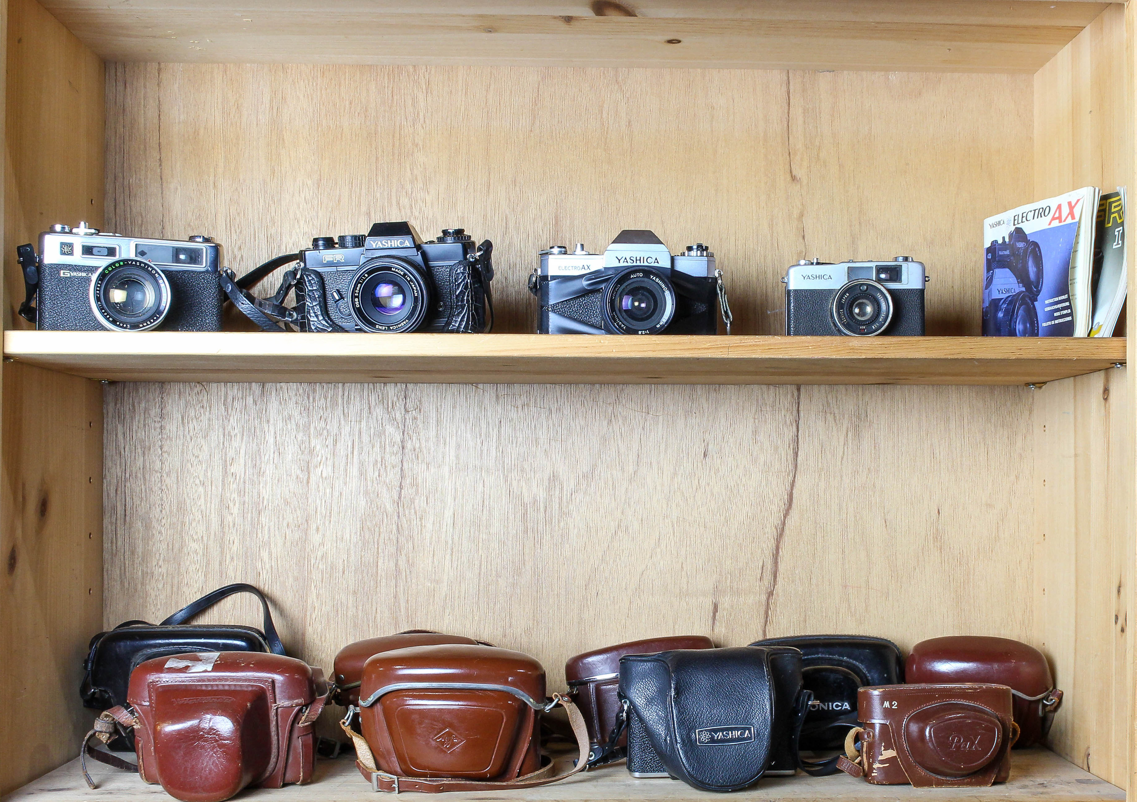 TWO SHELVES OF VINTAGE CAMERAS