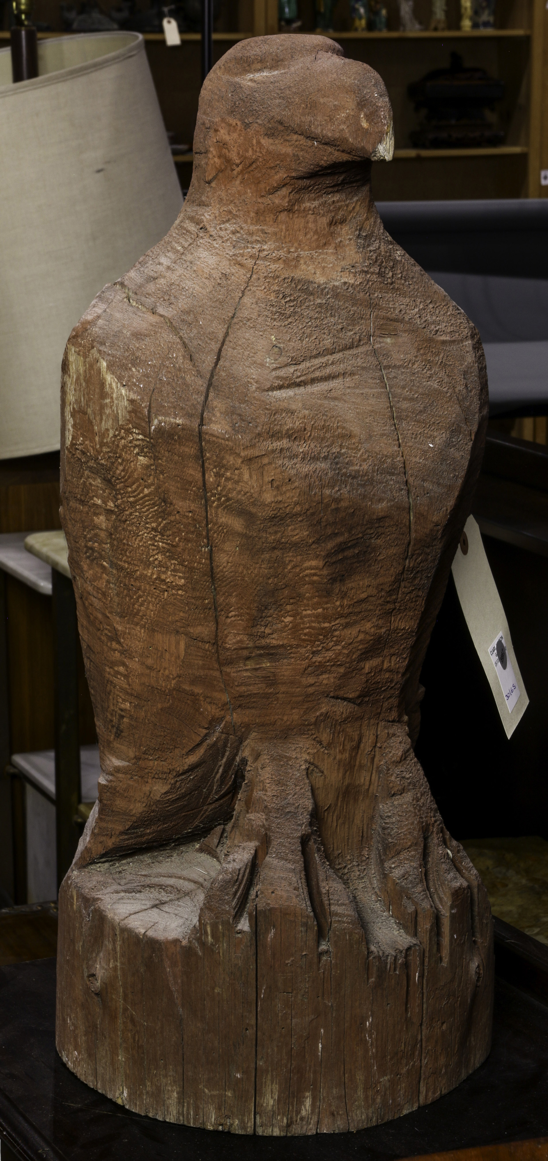 A CARVED WOOD FIGURE OF AN EAGLE A carved
