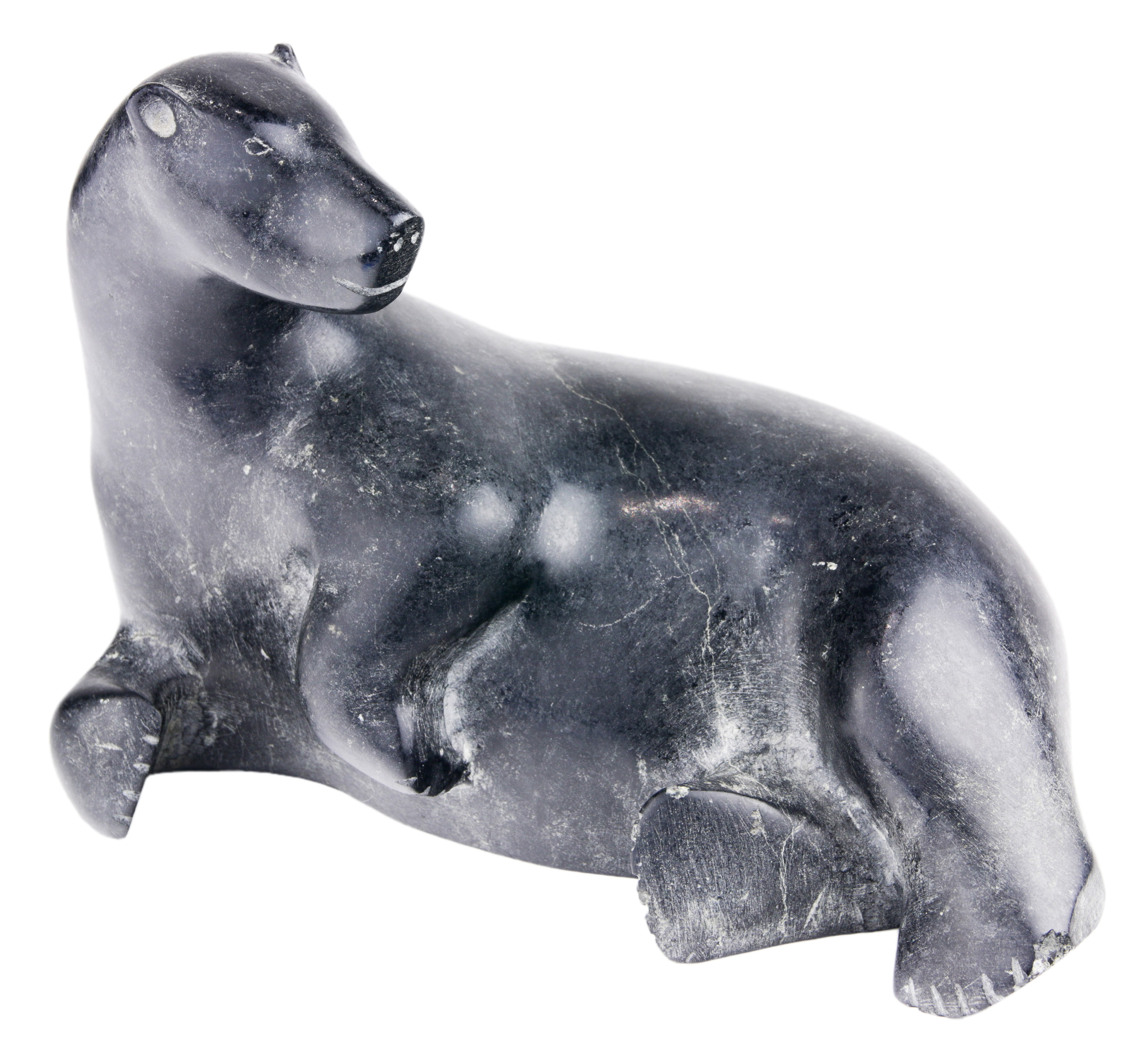 AN INUIT FIGURAL SCULPTURE OF A RECLINING