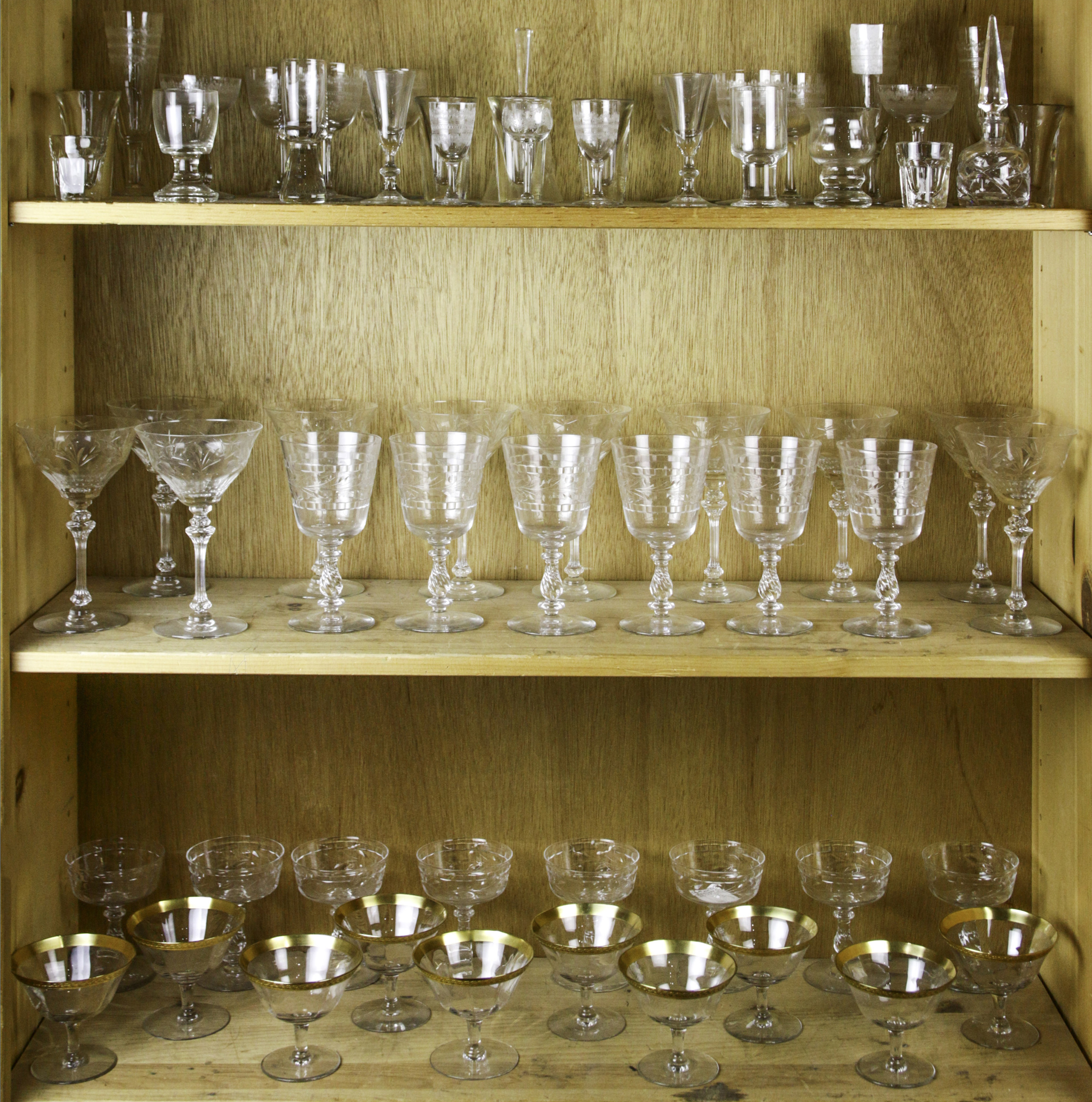THREE SHELVES OF ETCHED GLASS STEMWARE