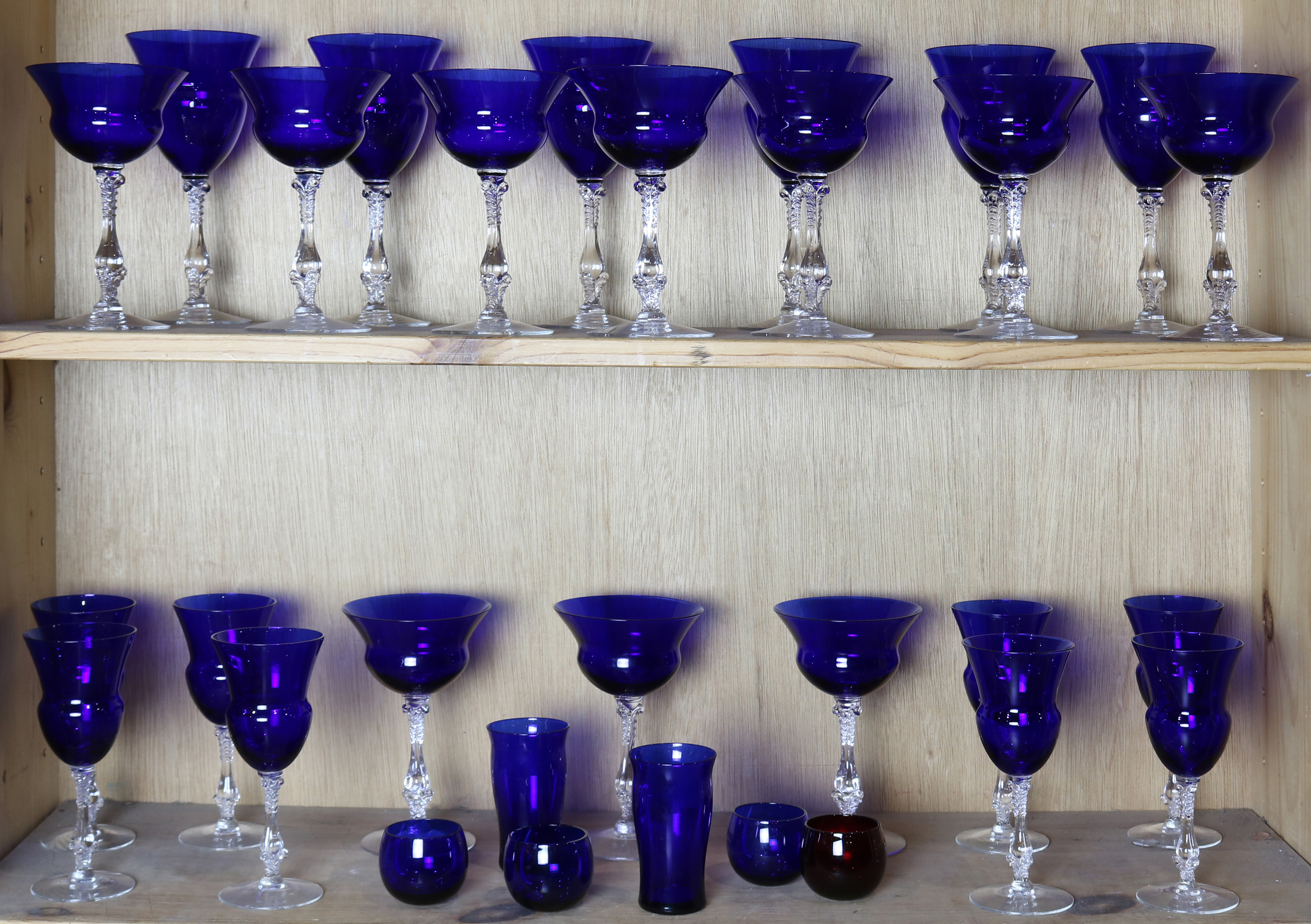 TWO SHELVES OF COBALT CUT TO CLEAR GOBLETS