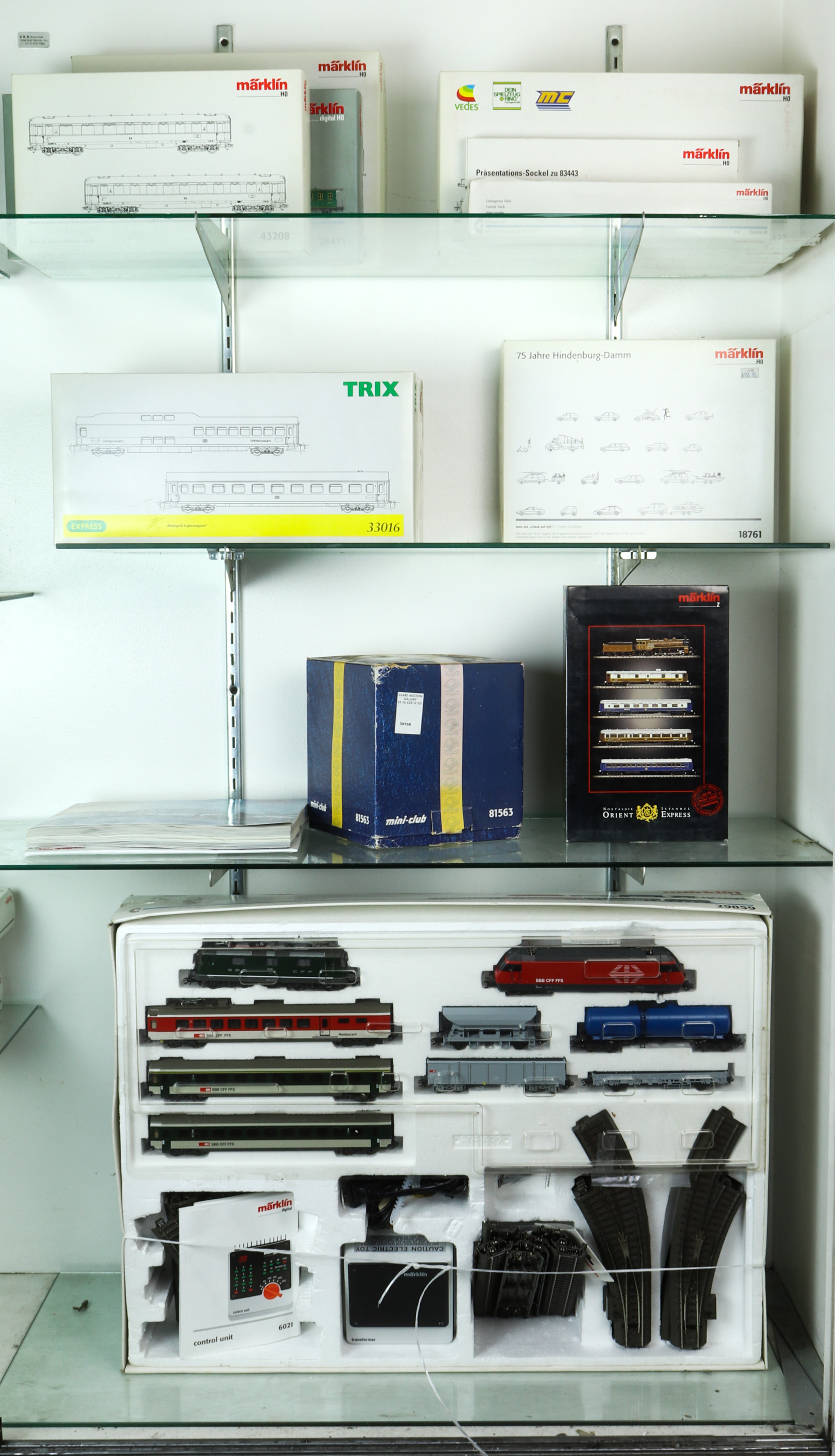 FOUR SHELVES OF BOXED MODEL TRAINS INCLUDING
