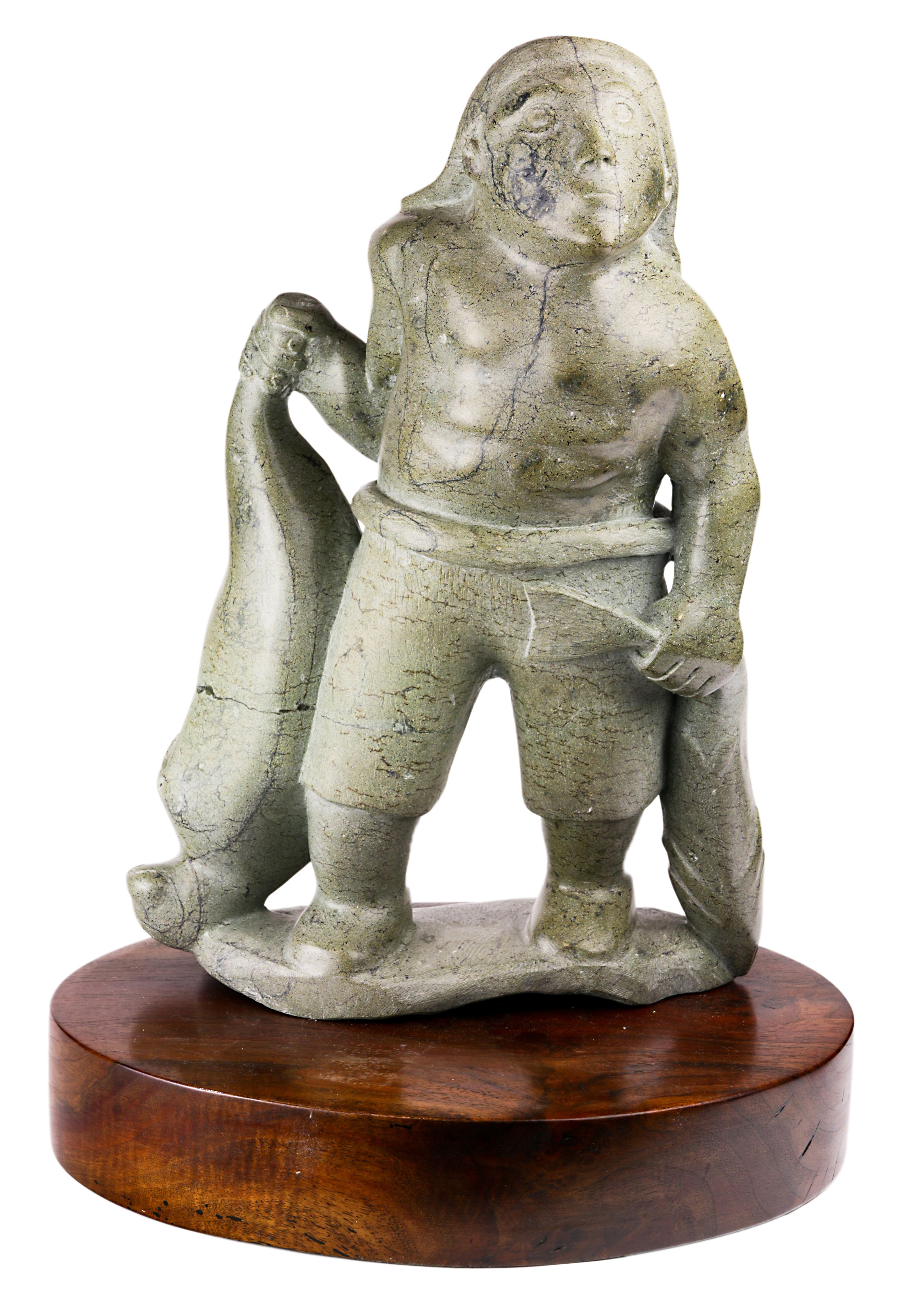 A LARGE INUIT STONE SCULPTURE OF A HUNTER