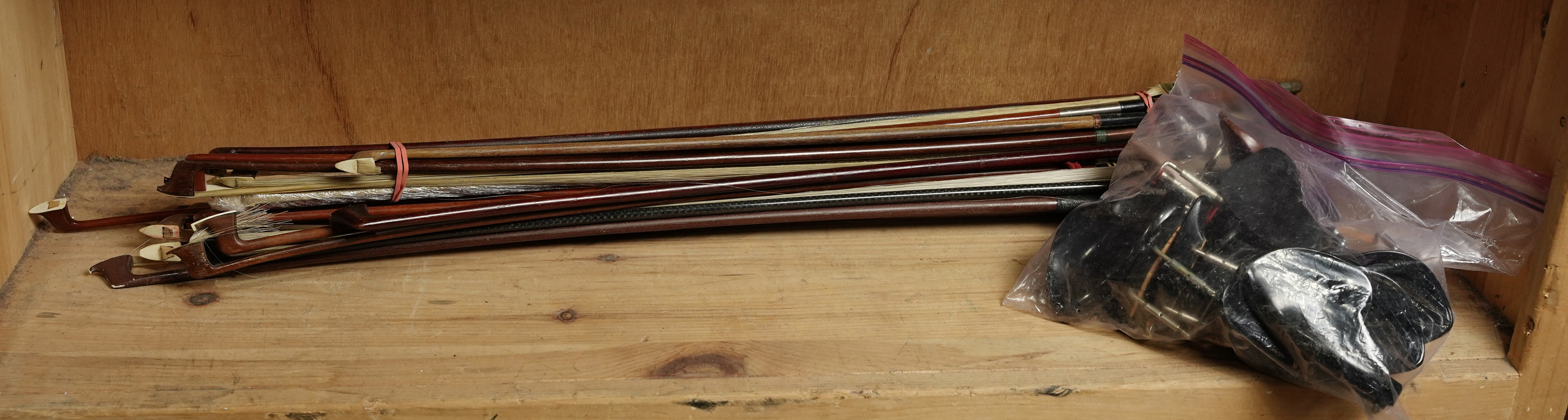 A COLLECTION OF VIOLIN BOWS AND