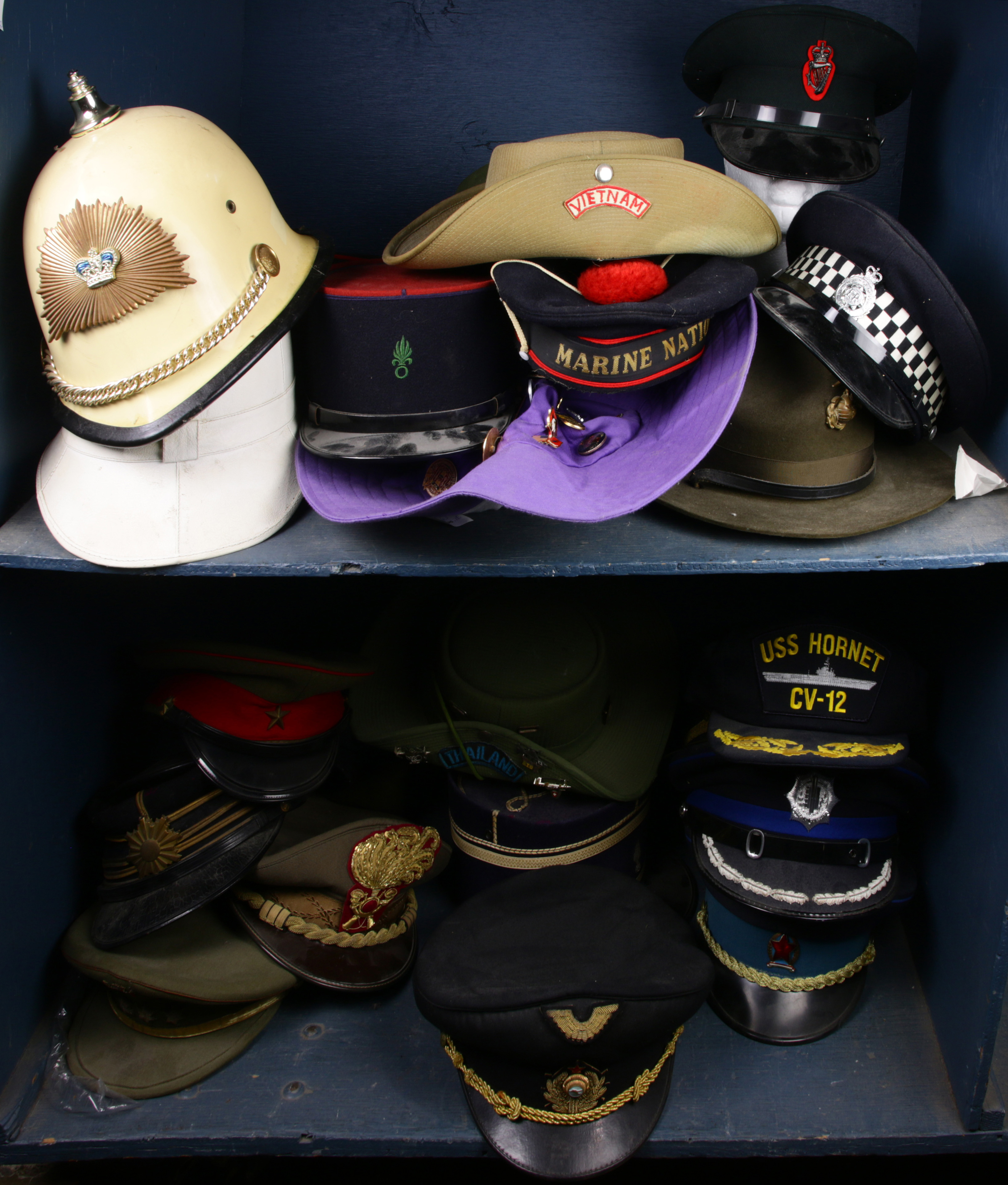 TWO SHELVES OF MILITARY HATS Two