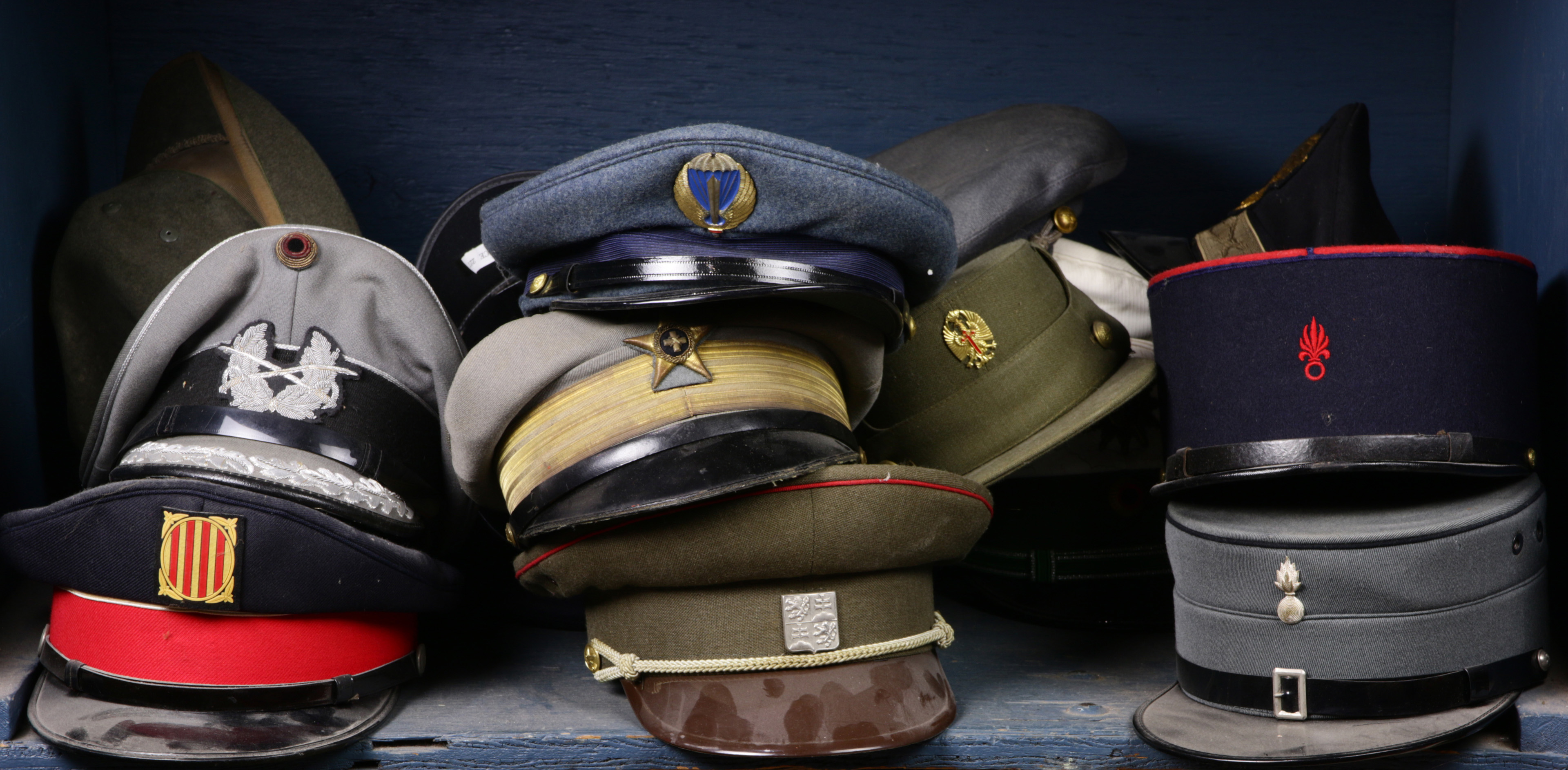 ONE SHELF OF MILITARY HATS One