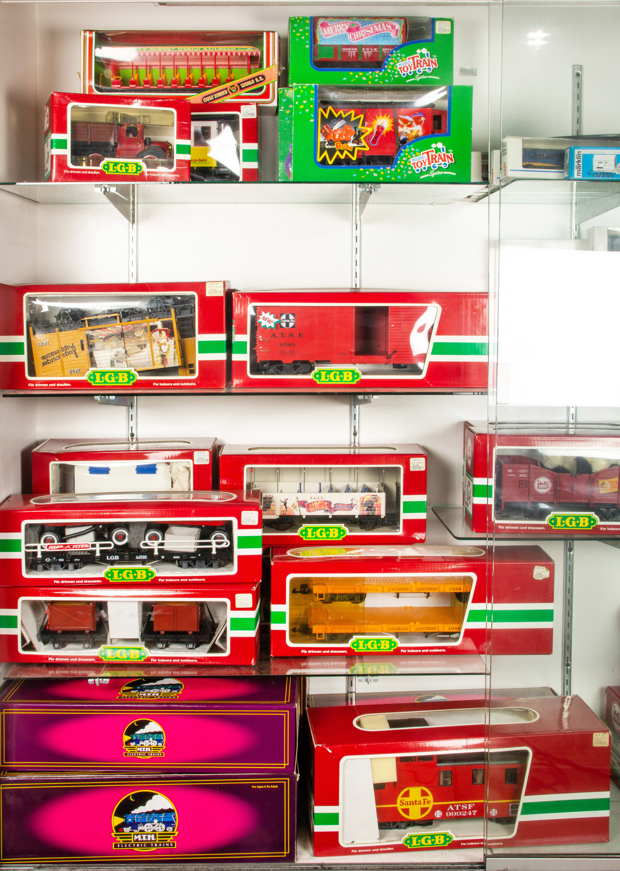 FOUR SHELVES OF BOXED MODEL TRAINS,