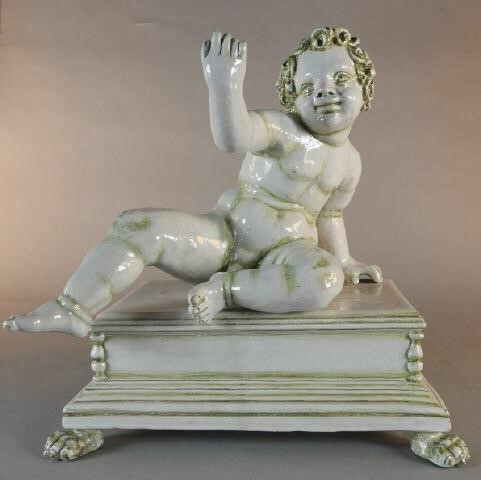 TIN-GLAZED MAJOLICA FIGURE OF PUTTO,