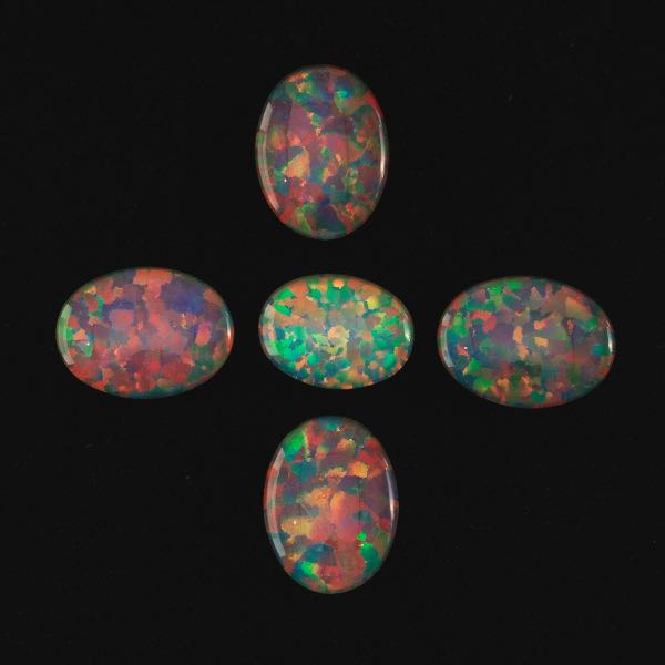 FIVE UNMOUNTED CABOCHON OVAL CUT