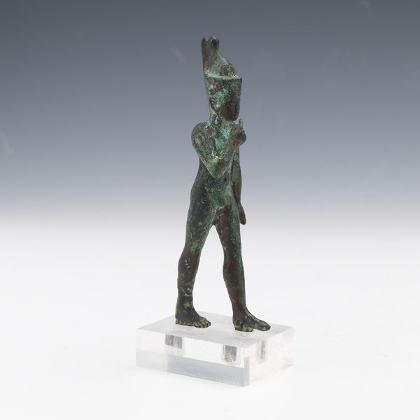 AN EGYPTIAN BRONZE FIGURE OF HARPOCRATES,