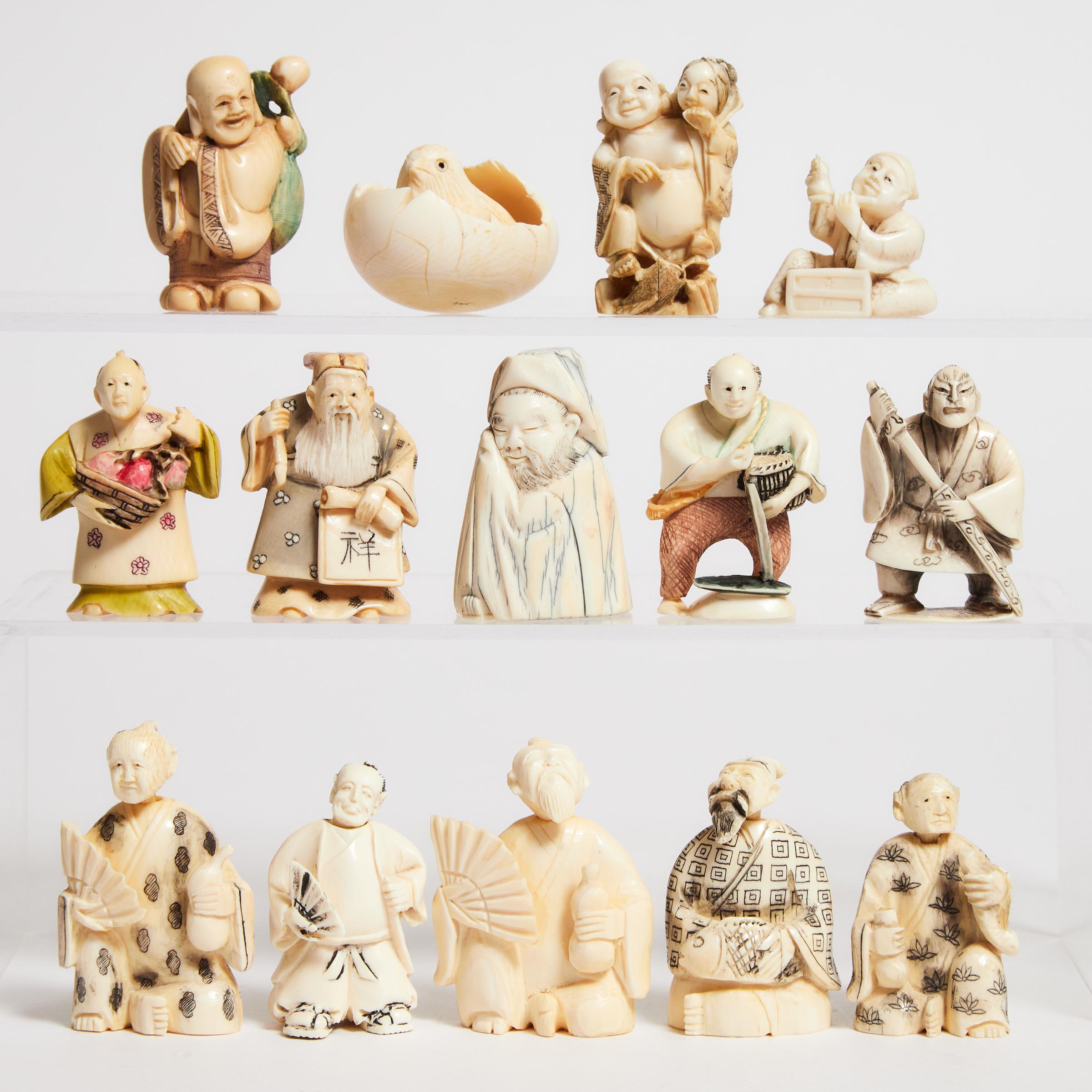 A Group of Fourteen Ivory Netsuke and