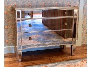 A contemporary three drawer mirrored
