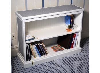 A white painted wood bookshelf