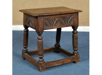 An antique English oak joint stool