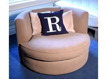 A light brown upholstered round