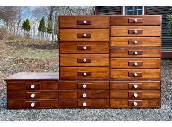 An antique two-part pine 20-drawer