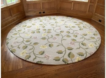 A round machine made rug, depicting