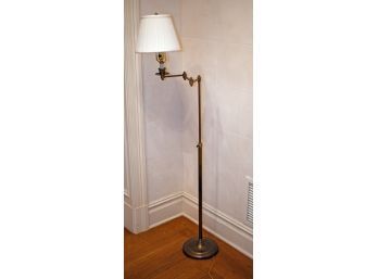 An adjustable brass floor lamp