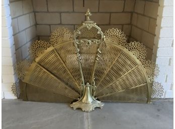 A vintage brass folding, fan shaped