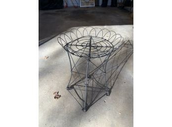 An antique wire plant stand with 3ab4d8