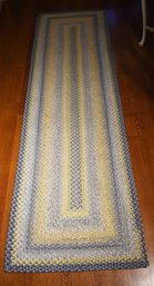 A flat weave braided hall runner,