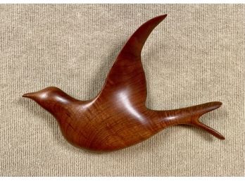 A contemporary carved walnut bird