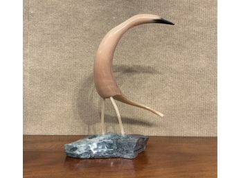 Carved horn bird mounted on stone,