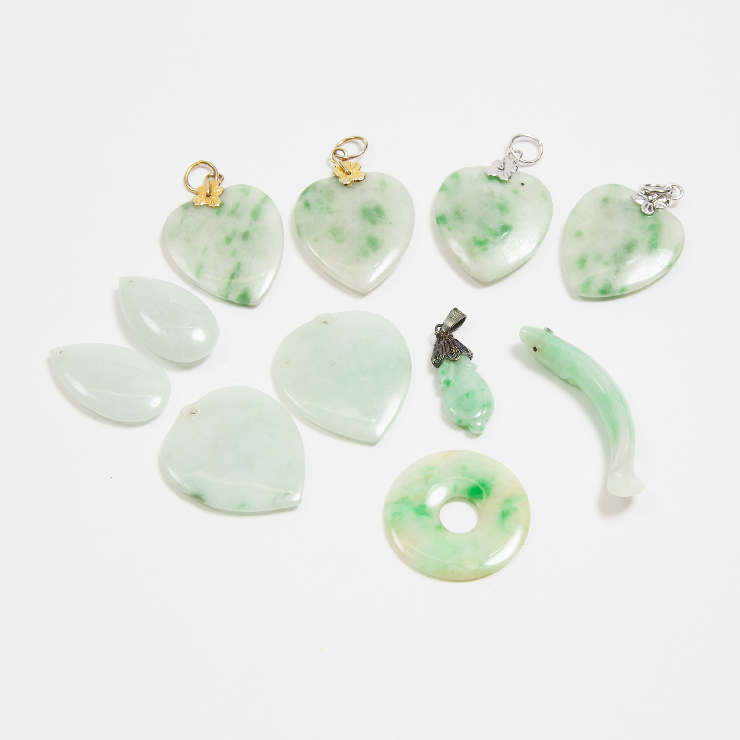 A Group of Eleven Jadeite Pendants  3ab94e