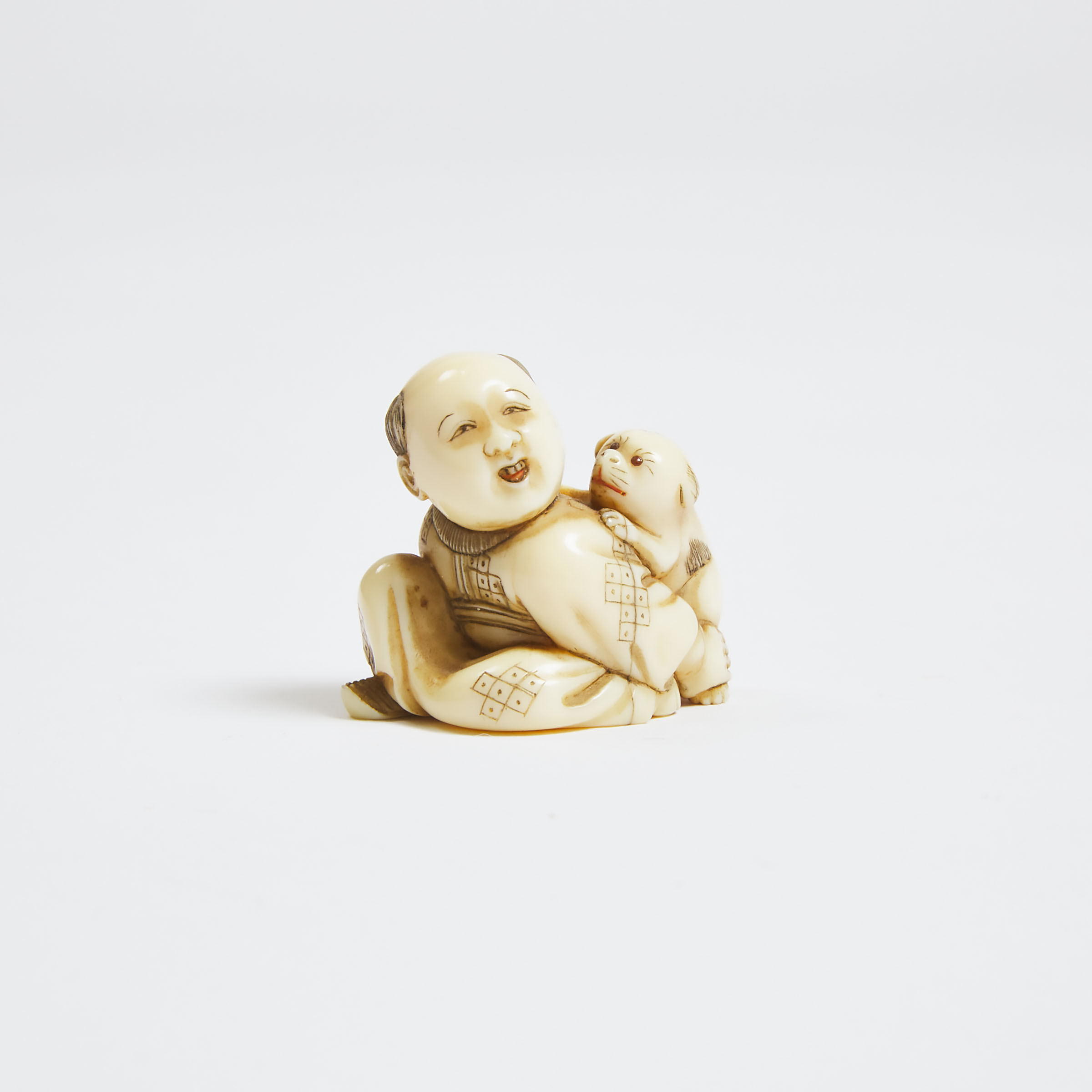 A Netsuke of a Boy Holding a Puppy  3abe7a