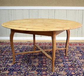 A round English antique pine dining