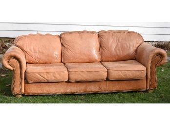 A vintage three cushion sofa, stamped